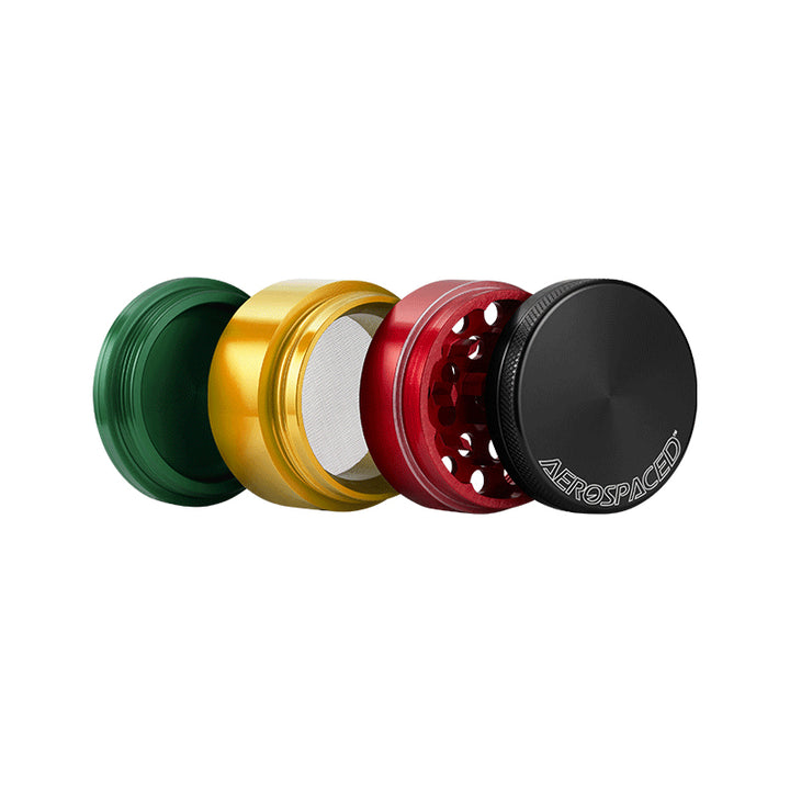 Open Rasta coloured 4 piece Aerospaced grinder, against a white background.